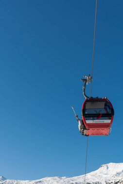 modern cable car cabins transport skiers to the ski resort of Le
