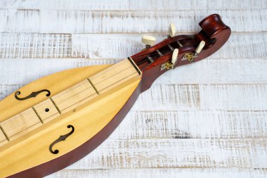 Appalachian mountain dulcimer musical instrument on a rustic whi clipart