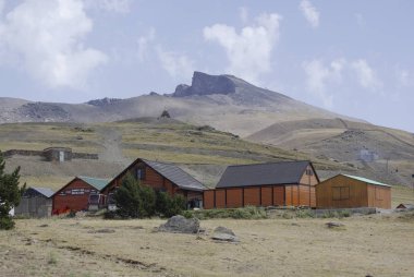Wooden huts in Sierra Nevada, the highest peaks of inland Spain. clipart