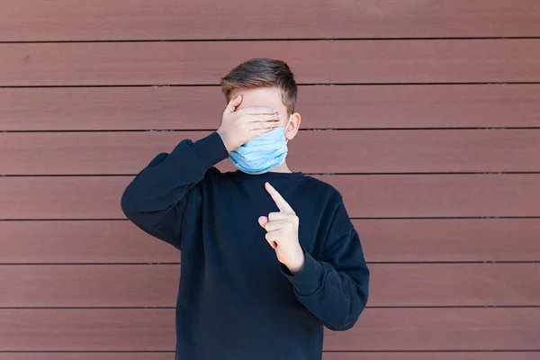 Boy Standing Protection Face Mask Shields Eyes His Hand Points — Stock Photo, Image