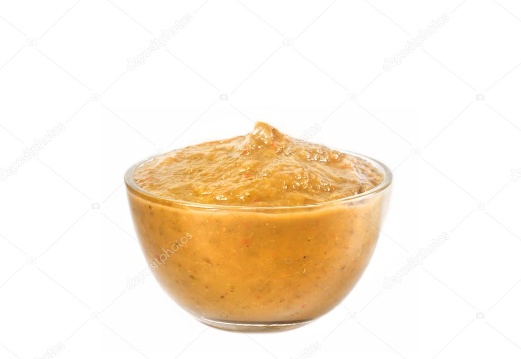 Vegetable sauce in a glass bowl close-up on a white background