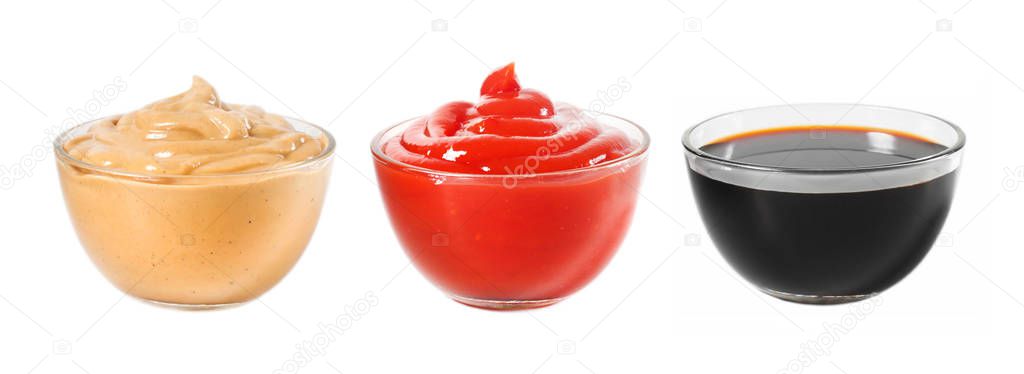 Several different sauces in a glass bowl on a white background