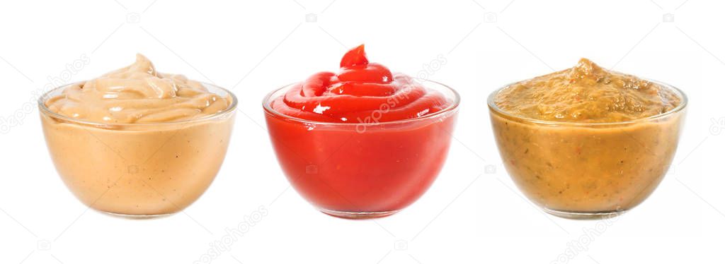Several different sauces in a glass bowl on a white background