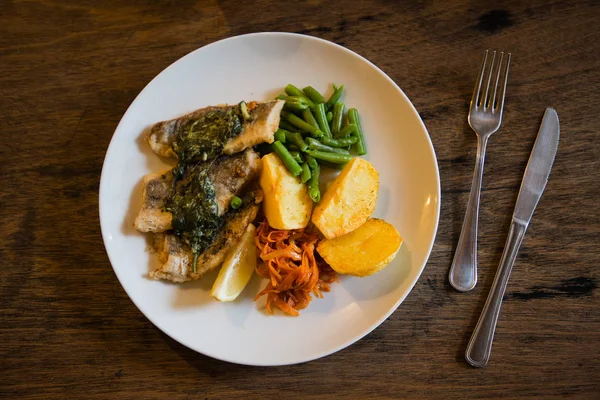 stock image fish and chips plate with vegetables and lemon on a plate