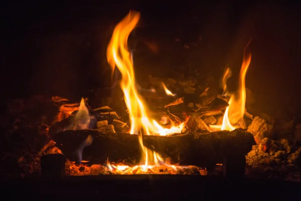 Fire flames with ash in fireplace — Stock Photo, Image