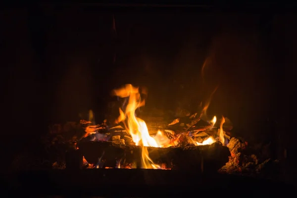 Fire flames with ash in fireplace — Stock Photo, Image