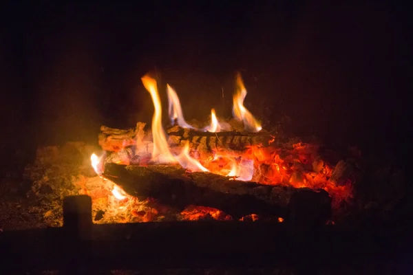 Fire flames with ash in fireplace — Stock Photo, Image