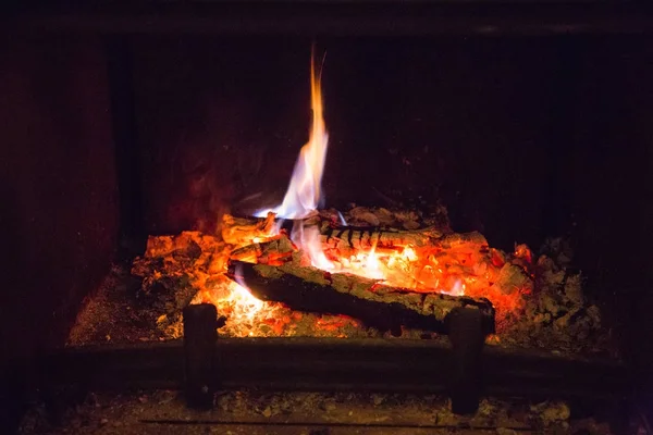 Fire flames with ash in fireplace — Stock Photo, Image