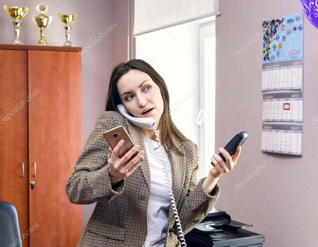 Girl Secretary works in the office, a lot of talking on the phone. hard work.
