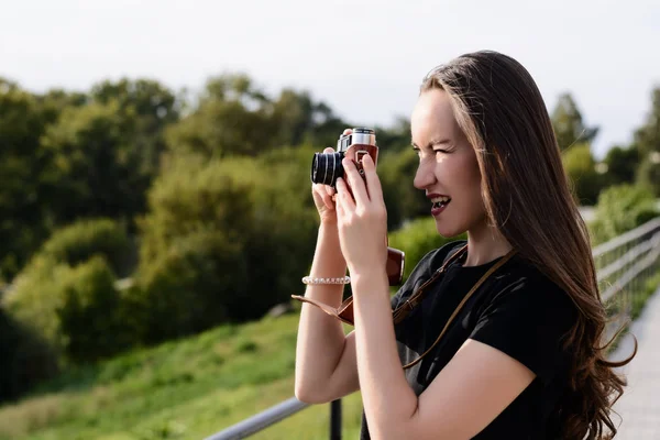 Jeune photographe heureuse marche dans le parc avec un appareil photo rétro — Photo