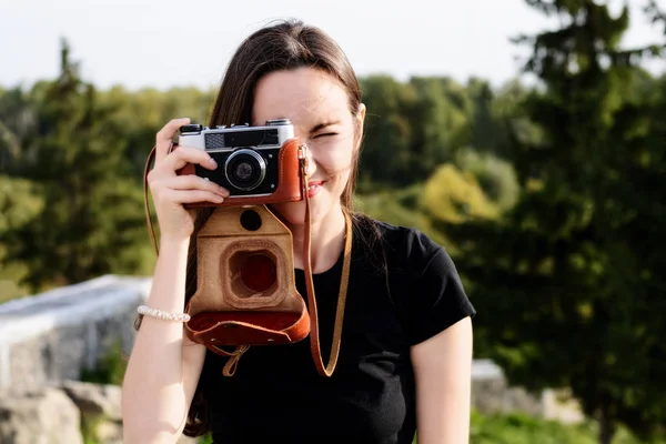 Jeune photographe heureuse marche dans le parc avec un appareil photo rétro — Photo
