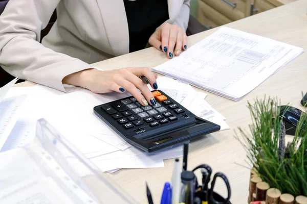 Young business woman working hard over the Desk in the study, economist accountant financial reporting, verifies accuracy of documents. Severe mental work — Stock Photo, Image