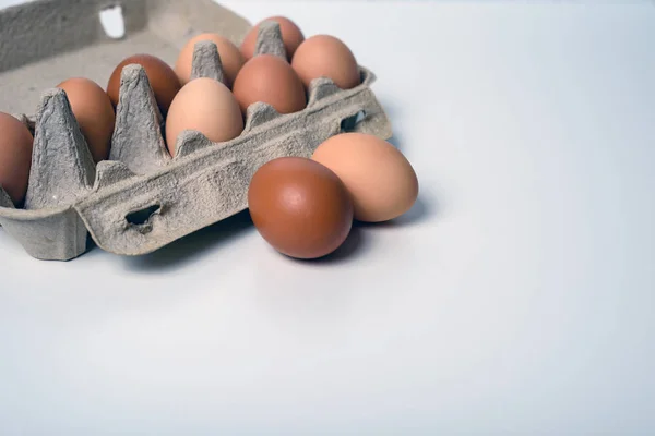 Minimalistic still life with rustic eggs in a paper container