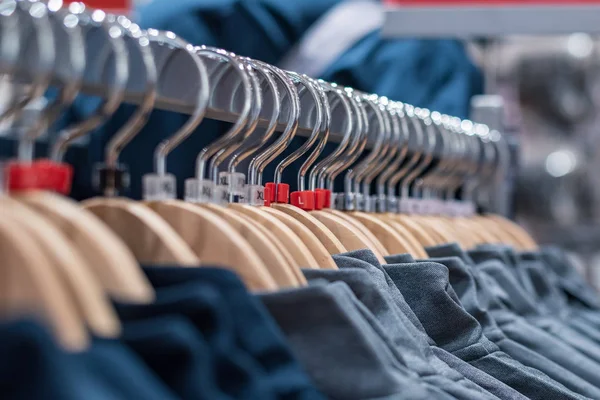 Clothes on hangers on racks in mass market