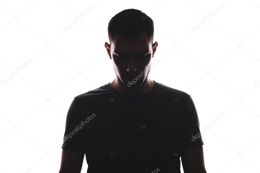 Silhouette of full-face portrait of man looking down, isolated on white background