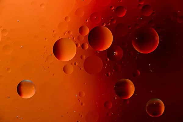 Krople oleju pomarańczowego na powierzchni wody z efektem duotonu — Zdjęcie stockowe
