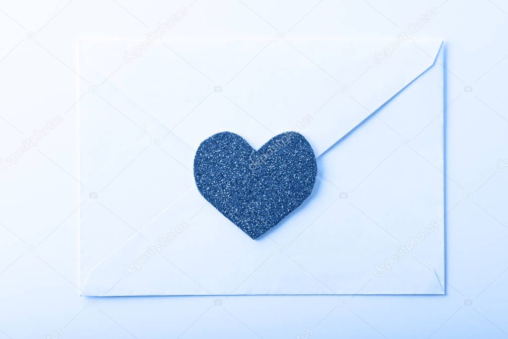 love e-mail letter in white envelope with heart on tinted in color of the year-classic blue background