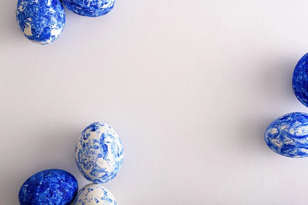 Top view Easter eggs in white and classic blue on white background — 스톡 사진