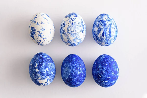 Six Easter eggs in the color of the year-classic blue with gradient effect in two rows on white background — 스톡 사진