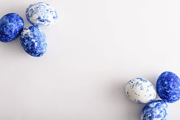 Easter eggs in the color of the year-classic blue at the corners on white background — 스톡 사진