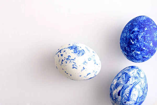 Three Easter eggs in the color of the year-classic blue with a gradient effect on white background — 스톡 사진