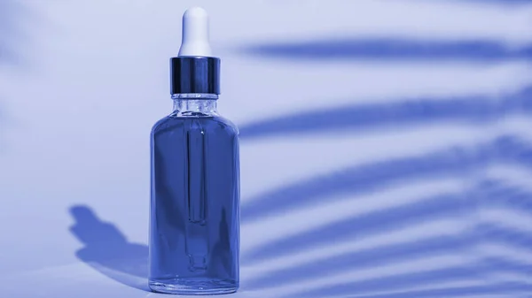 色彩艳丽的化妆品瓶经典的蓝色衬托背景阴影与复制空间 投瓶概念 — 图库照片