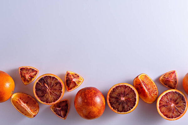 top view slices, halves of red orange on white background with copy space, citrus background, fruit frame