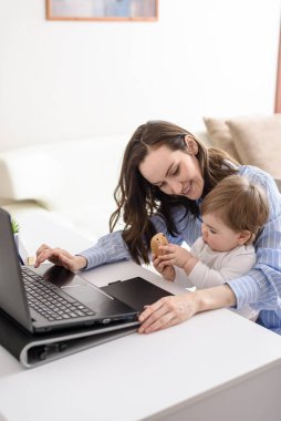 smiling woman mother with child sitting at laptop and communicating with baby, happy motherhood on maternity leave, freelancer, remote work at home, vertical clipart