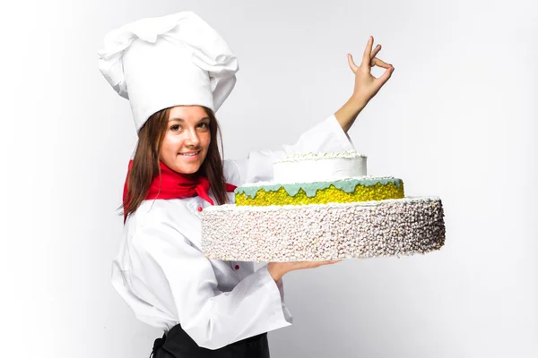 woman chef holding a cake