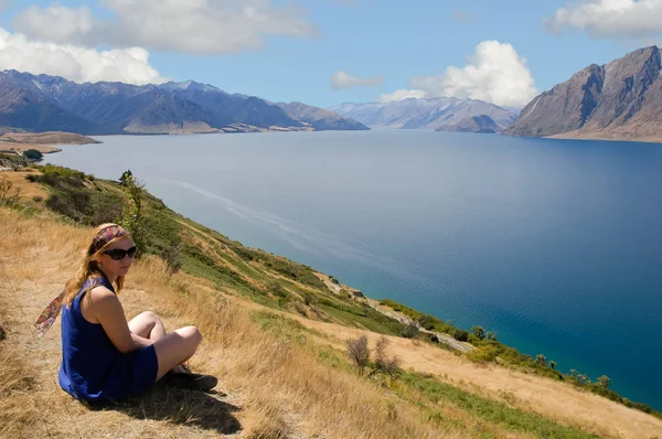 Mulher da Nova Zelândia desfrutando do sol e bela vista para o lago — Fotografia de Stock