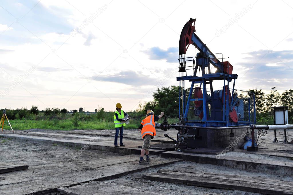 Two petroleum engineers at work on an European oil well   