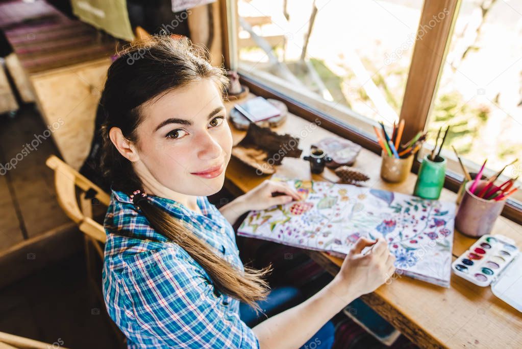 Beautiful young painter in her studio