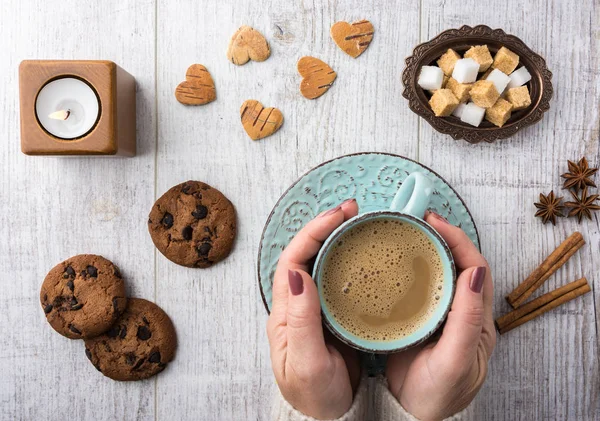 Stock image  Women drinking coffee with milk and eating cookies top view