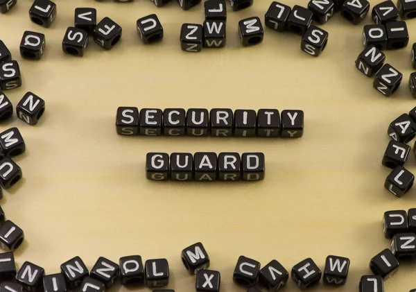 La palabra guardia de seguridad sobre fondo de madera — Foto de Stock