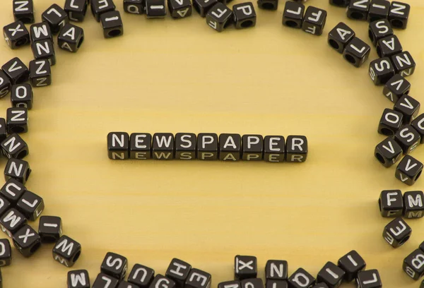 The word newspaper on wood background — Stock Photo, Image
