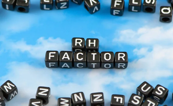 The word Rh factor on the sky background
