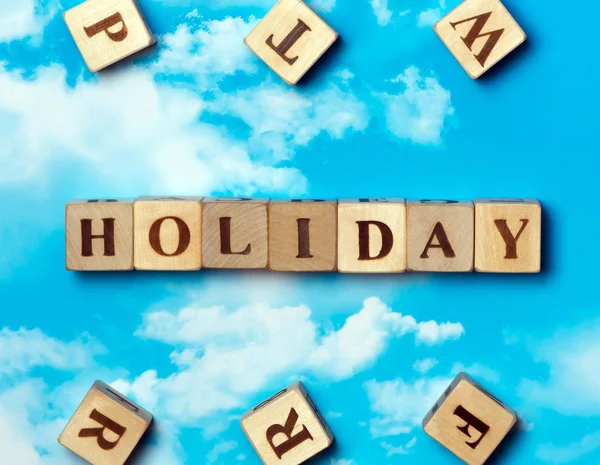 The word holiday on the sky background — Stock Photo, Image