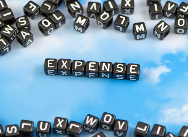 The word expense on the sky background