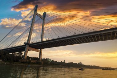 Vidyasagar Setu (köprü) olarak alacakaranlık nehirde Hooghly bir tekne görüldüğü gibi. Kolkata, Hindistan.