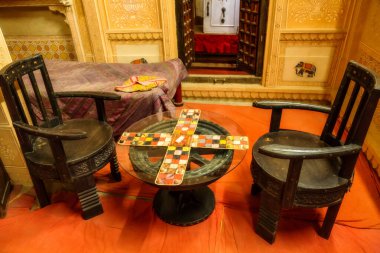 Heritage building Patwon ki Haveli royal palace room interior with old furniture and vintage board game on display at Rajasthan, India clipart