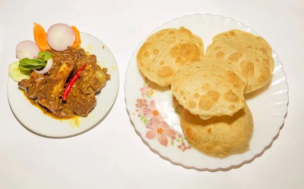 Traditional Indian meal - Poori made of flour served with spicy gravy mutton kosha. A popular Indian food.