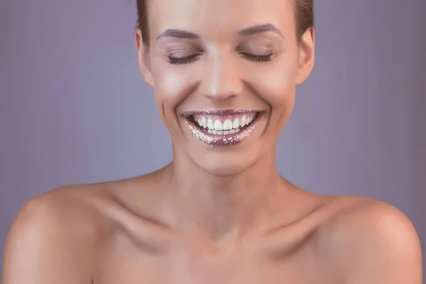 Perfect teeth smile with tinsel lips. Beautiful close up tanned Face of Young Woman with Clean Fresh Skin in retro style. Beautiful Spa Woman laugh. Perfect Fresh Skin. Youth and Skin Care Concept