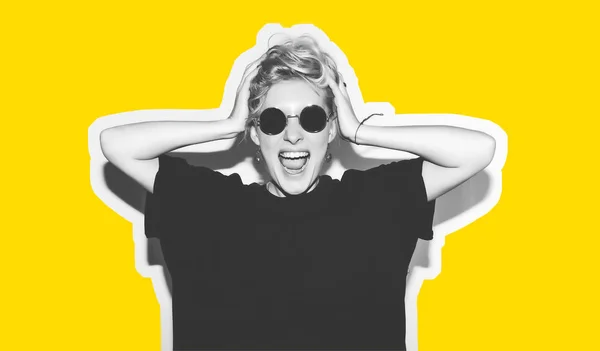 Stylish fashion blonde with short hair colorful collage. Crazy girl in a black t-shirt and rock sunglasses scream holding her head. Rocky emotional woman. white toned. yellow background, not isolated — Stock Photo, Image