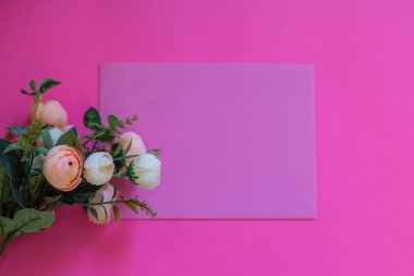 Framework from roses on pink background. Flat lay. Top view