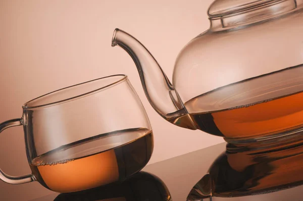 Transparent glass teapot and cup with tea — Stock Photo, Image