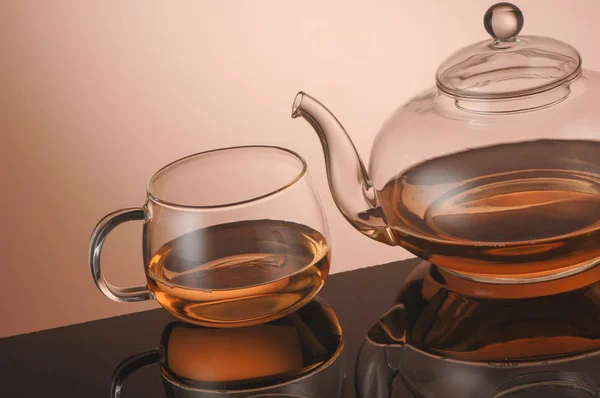 Transparent glass teapot and cup with tea — Stock Photo, Image