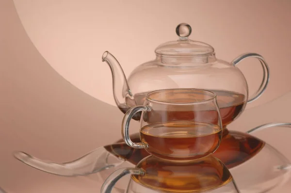 Transparent glass teapot and cup with tea — Stock Photo, Image