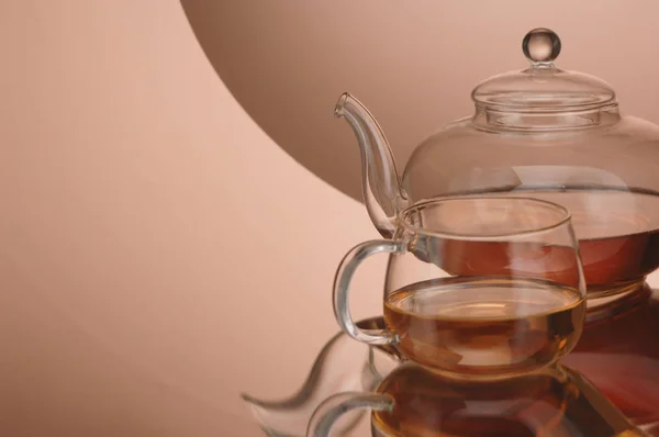 Transparent glass teapot and cup with tea — Stock Photo, Image