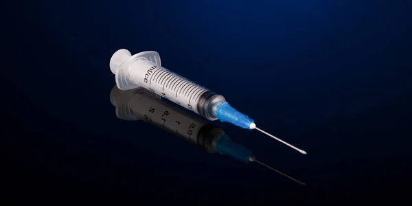 Medical syringe on a dark background — Stock Photo, Image