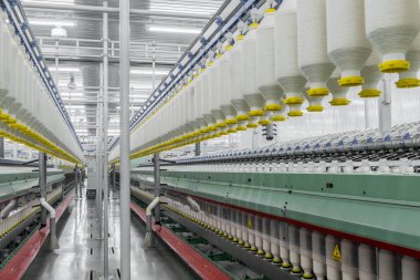 spools of thread at a textile factory clipart